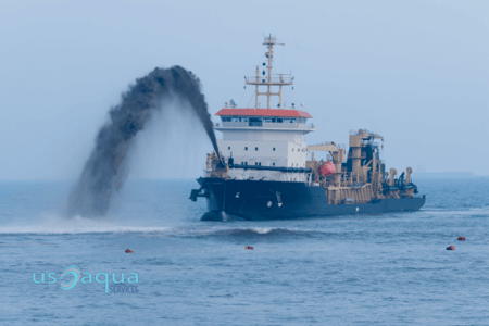 A large boat in the middle of the ocean, using a jet lift dredger to move sediment, rented from US Aqua (1)