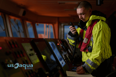 A male worker in the control room of a large ship, giving instructions to workers using an autonomous dredger rented by U.S Aqua (1)
