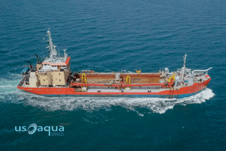 Red trailing suction hopper dredging boat roaring across the sea, by U.S Aqua (1)