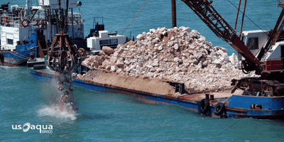 Large dredging equipment distributing dredged material into the gulf