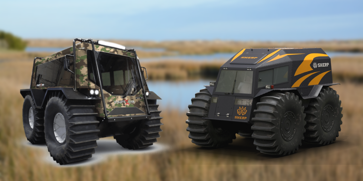 A U.S. Aqua provided Fat-Truck amphibious personnel carrier and a Sherp personnel carrier side by side over the backdrop of a marshy environment