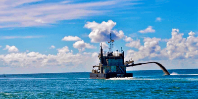 Boat dredging in the ocean