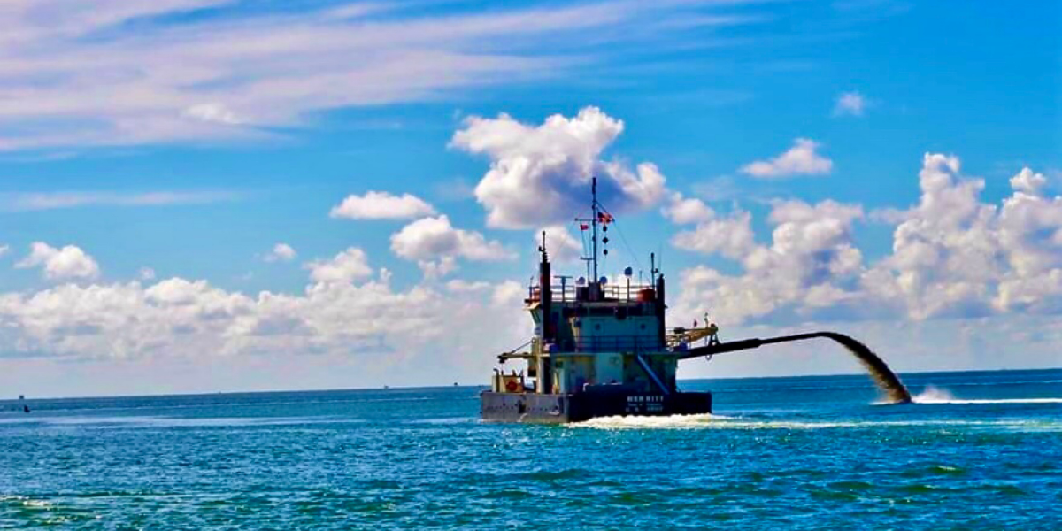 Boat dredging in the ocean
